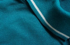Green polo shirt texture, cotton fabric. Textile background
